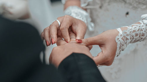 Midsection of couple holding hands