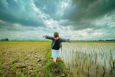 A boy who was playing in the rice field happily