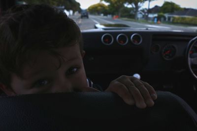 Close-up portrait of boy sitting in car