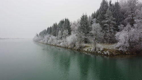 Scenic view of lake against sky during winter