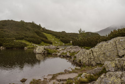 Scenic view of lake and mountains against sky