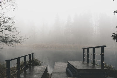 Pier over lake against sky