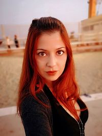 Portrait of beautiful young woman with redhead