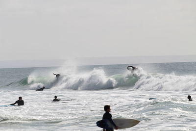 Man surfing on sea against clear sky