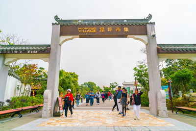 Group of people walking in front of building