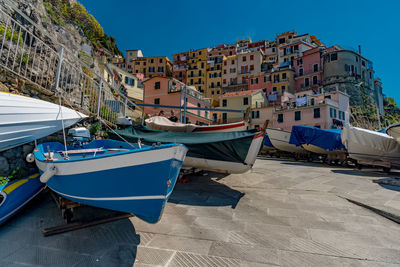 Boats moored on harbor against buildings