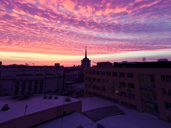 View of cityscape during winter at sunset