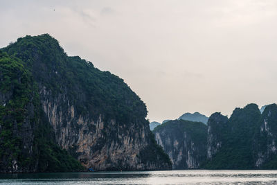 Scenic view of sea and mountains against sky