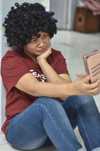 Midsection of woman using mobile phone