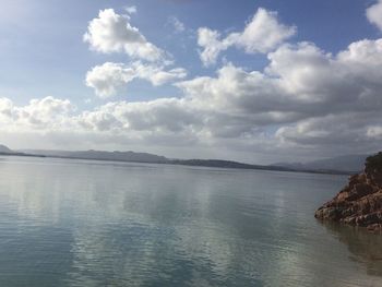 Scenic view of sea and mountains against sky