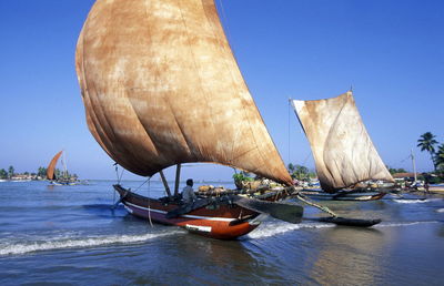 Man on boat moored at beach