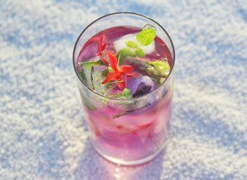 Refreshing pink lemonade with herbs.