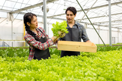 Young woman standing in greenhouse