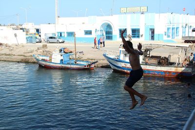 Side view of a boy jumping into the river