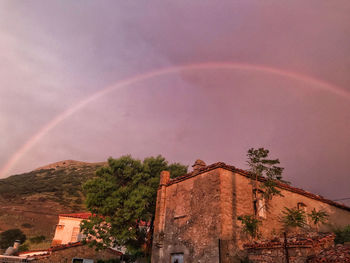 Low angle view of rainbow over building