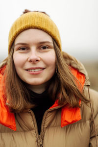 Portrait of young woman smiling outdoors