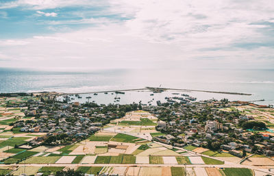 High angle view of townscape by sea against sky