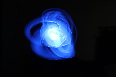 Close-up of light bulb over black background