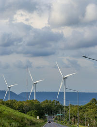 The large vaned wheel rotated by the wind to generate electricity. white windmill of pea 