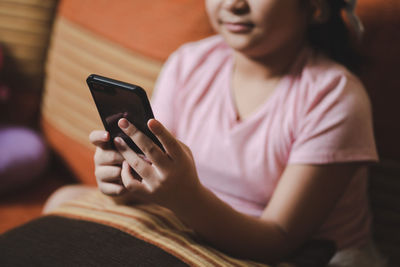 Midsection of woman using mobile phone