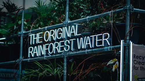 Low angle view of information sign against trees