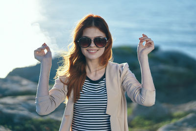 Young woman wearing sunglasses standing outdoors