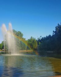 View of fountain in lake against sky