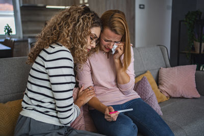 Side view of mother and daughter at home