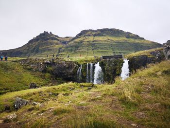 Scenic view of waterfall against sky