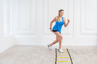 Full length of woman exercising at gym