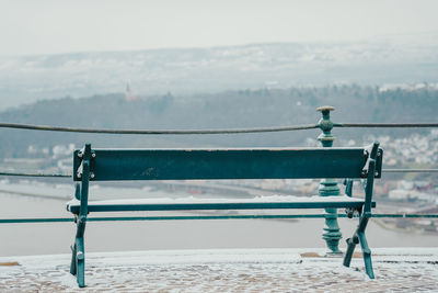 Close-up of railing on pier over sea against sky