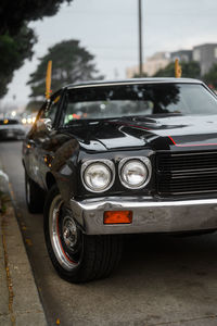 Close-up of vintage car on road