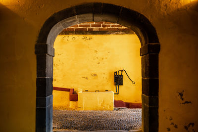 Entrance of old building. with a water pump