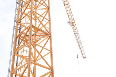 Low angle view of crane against sky