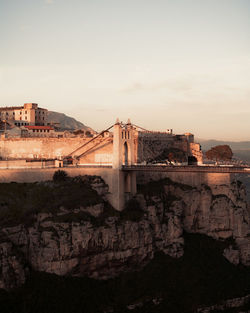 Historic buildings and bridge against sky