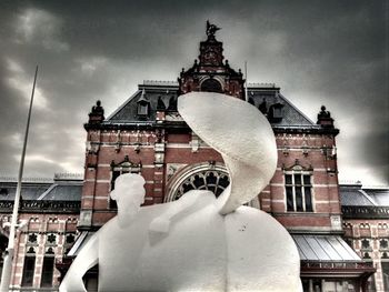 Low angle view of building against cloudy sky