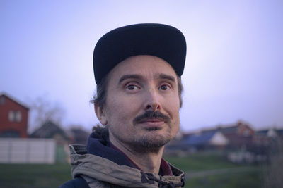 Portrait of young man against clear sky