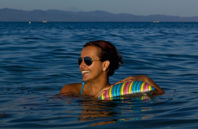 Portrait of smiling young woman in swimming pool