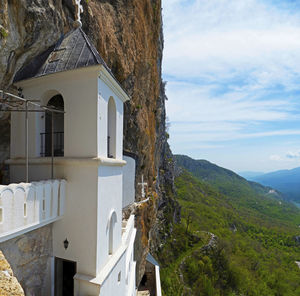 Building by mountain against sky