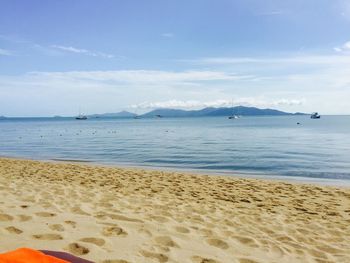 Scenic view of beach against cloudy sky