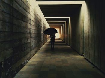 View of man walking in tunnel
