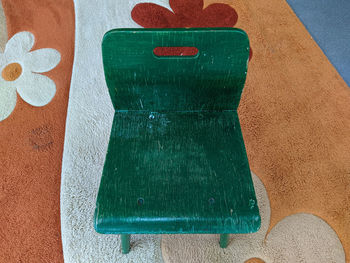 One small and children's wooden green chair with a back