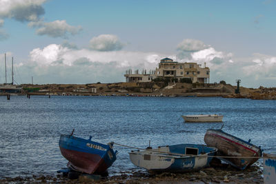 Boats moored on sea against sky