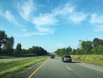 Cars on road against sky