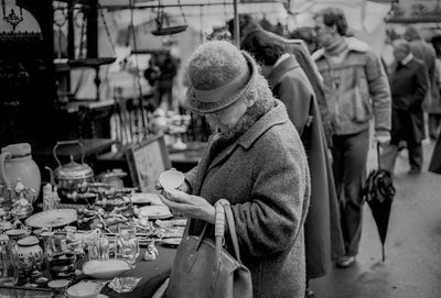 Senior woman standing at market stall