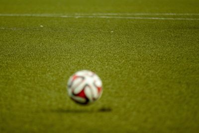 Close-up of soccer ball on field