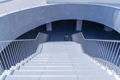 Rear view of man sitting on staircase