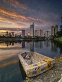 Reflection of buildings in lake during sunset