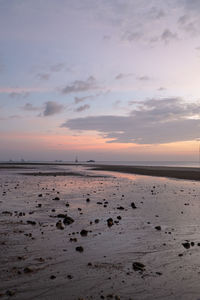 Scenic view of beach against sky during sunset