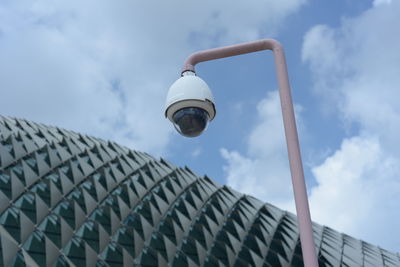 Low angle view of street light against building